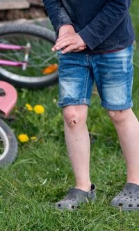 Low section of boy standing on grass