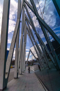 People walking on bridge against sky