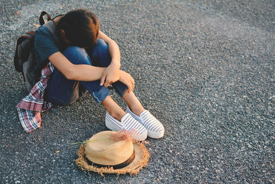 Young woman sitting on road