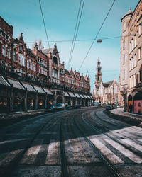 Street amidst buildings in city against sky