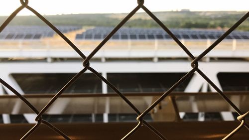 Close-up of chainlink fence against sky