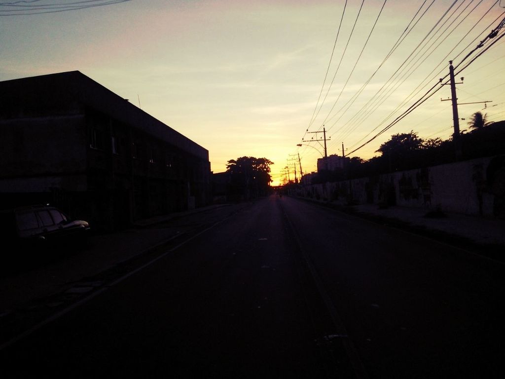 the way forward, sunset, power line, electricity pylon, transportation, building exterior, diminishing perspective, sky, vanishing point, built structure, architecture, road, street, electricity, silhouette, cable, long, railroad track, outdoors, cloud - sky