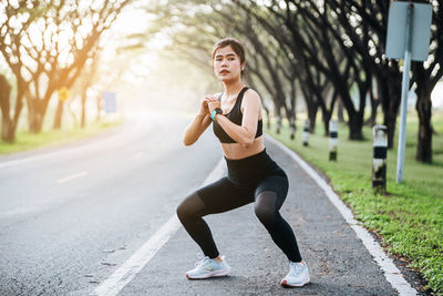 Young woman exercising on road