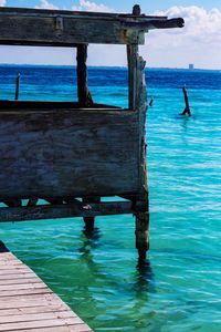 Swimming pool by sea against sky