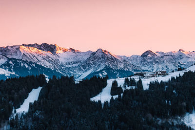 Snow covered mountains against sky during sunset