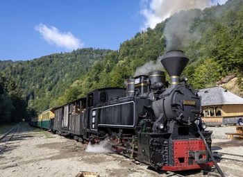 Train on railroad track against sky