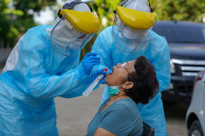 Rear view of a woman holding umbrella