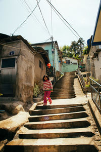 Rear view of girl walking on steps