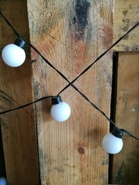 Low angle view of light bulb hanging on table