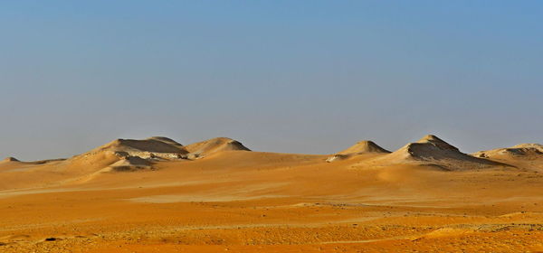 Scenic view of desert against clear sky