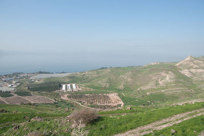 Scenic view of landscape and sea against sky