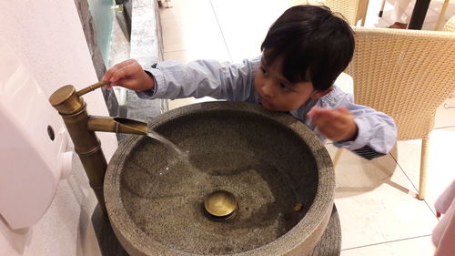 High angle view of boy making face at home