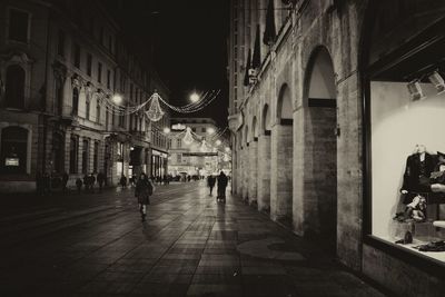 People walking in city at night