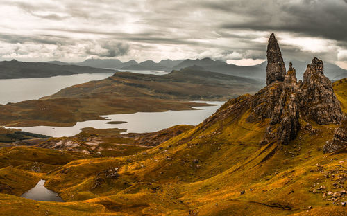 Scenic view of mountains against cloudy sky