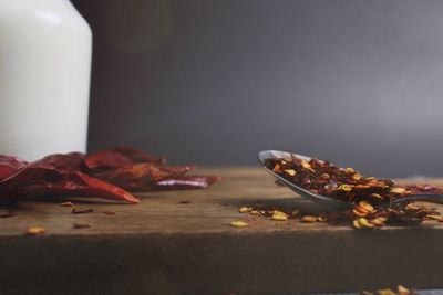 Close-up of chili flakes and spoon on table