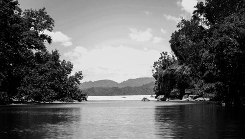 Scenic view of river and mountains against sky