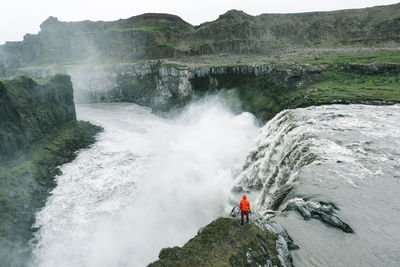 High angle view of man surfing on cliff against sky