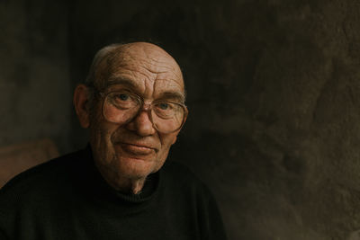 Close-up portrait of man against black background