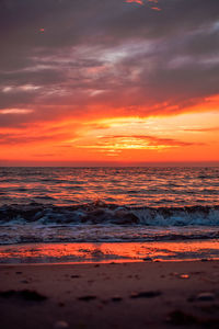 Scenic view of sea against romantic sky at sunset