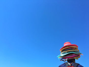 Low angle view of vendor against blue sky