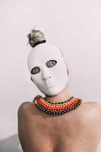 Portrait of person wearing mask against white background