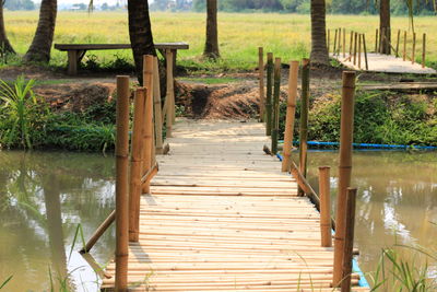 Wooden footbridge on pier over lake