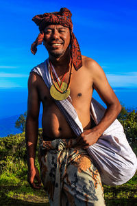 Portrait of man wearing traditional clothing against clear sky