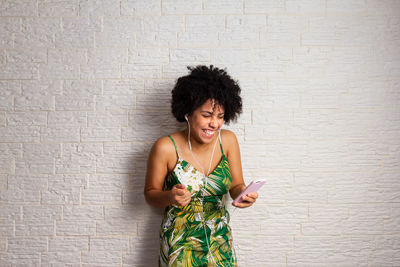 Rear view of woman standing against wall