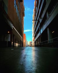 Street amidst buildings against sky in city