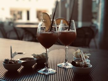 Close-up of wine glasses on table