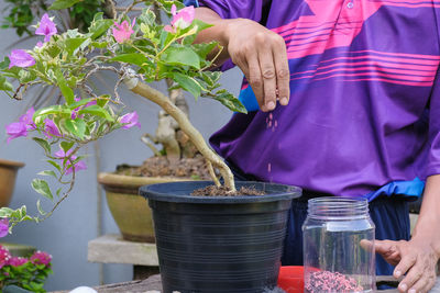 Man working on potted plant