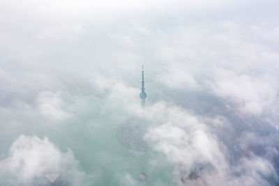 Low angle view of tower against cloudy sky