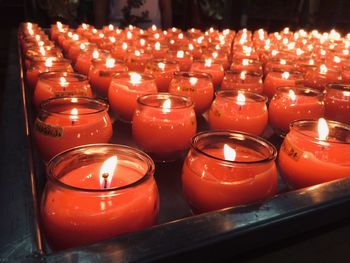 Various burning candles in temple
