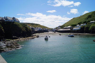 Scenic view of sea by buildings against sky