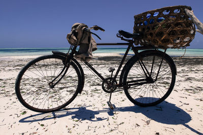 Basket on bicycle at beach