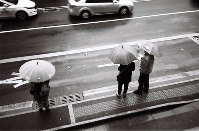 Rear view of people walking on road