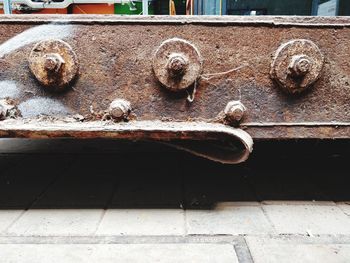 High angle view of old rusty metal on wood