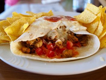 Close-up of burrito served in plate on table