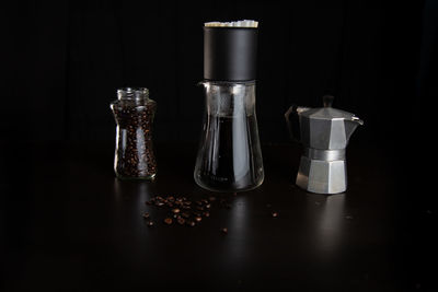 Close-up of wineglass on table against black background