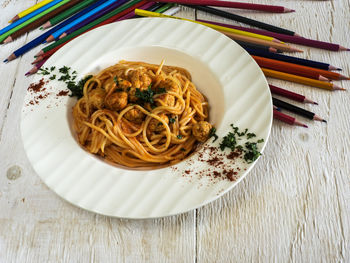 Close-up of spaghetti with chicken meatballs served in plate on table