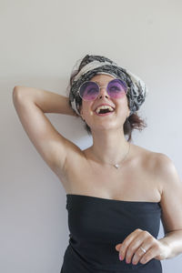 Portrait of a young woman wearing sunglasses and a bandana