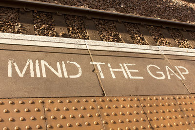 High angle view of text on railroad station platform