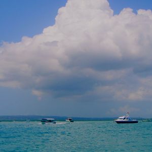 Sailboat sailing on sea against sky