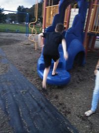 Rear view of people enjoying at playground