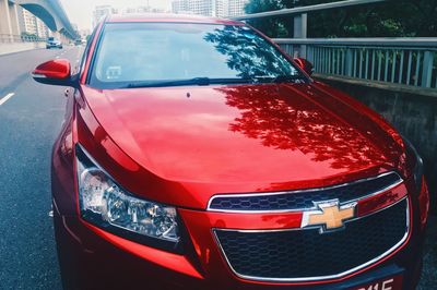 Close-up of red car on road