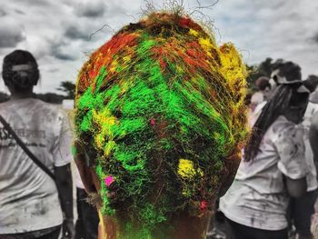 Rear view of woman standing against multi colored sky
