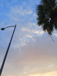 Low angle view of silhouette street light against sky