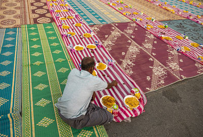 High angle view of woman holding multi colored umbrella