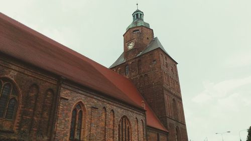 Low angle view of clock tower against sky