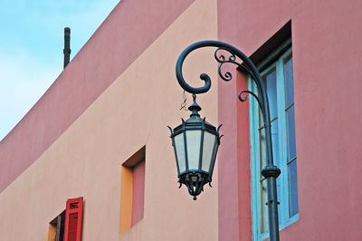 Low angle view of street light against building